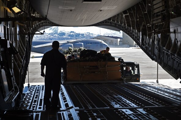 Airmen load cargo onto a C-17 Globemaster III at Joint Base Elmendorf-Richardson, Alaska, April 18, 2017. The cargo was later dropped during an Army training mission at the Malemute Drop Zone at JBER. The realistic training provides an opportunity for mobility Airmen assigned to the 732nd Air Mobility Squadron to interact with Army ground-force elements and allows the crossflow of information to boost communications between the branches. (U.S. Air Force photo by Airman 1st Class Valerie Monroy)

