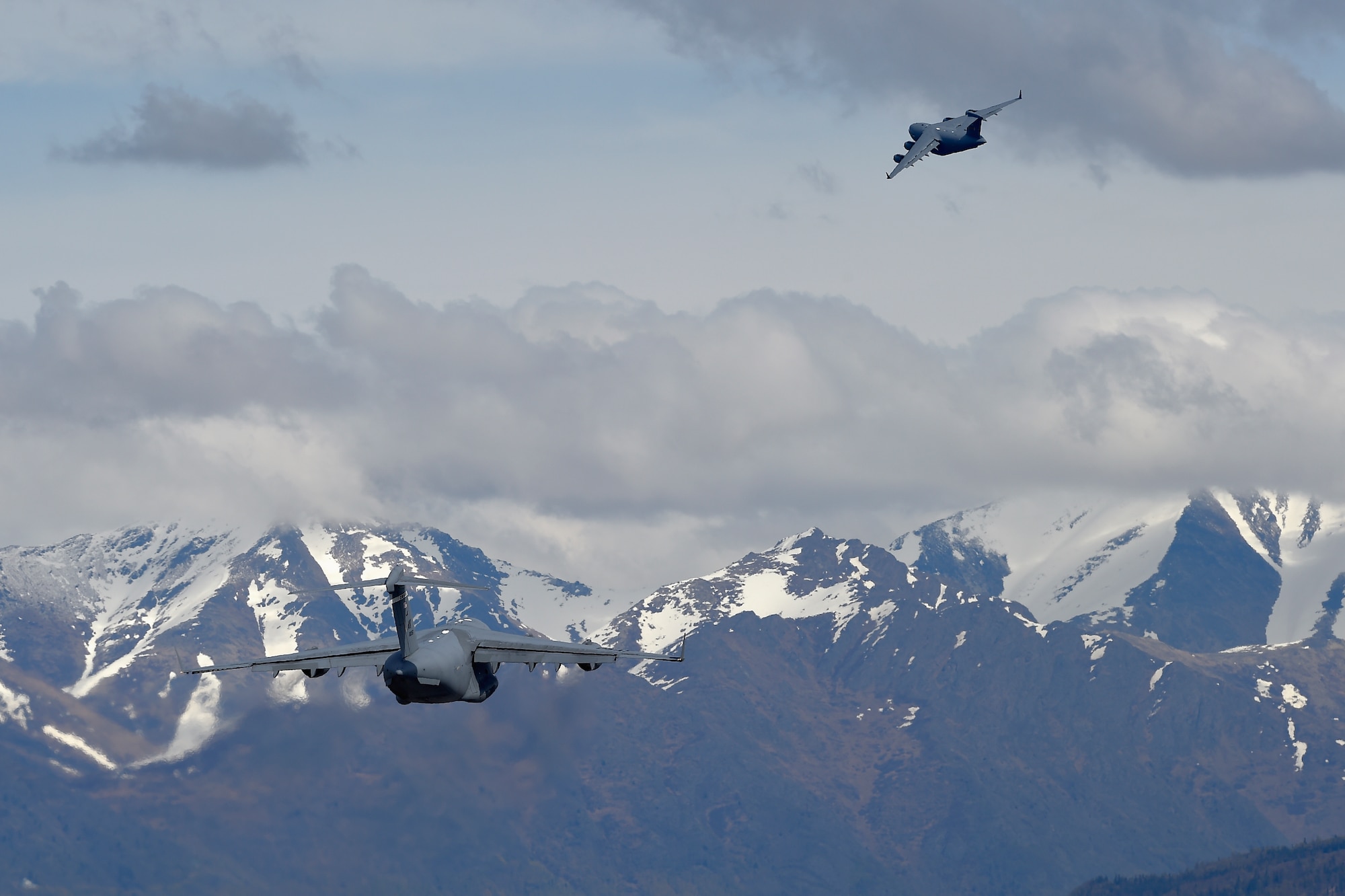 Two U.S. Air Force C-17 Globemaster IIIs take off from Joint Base Elmendorf-Richardson during Red Flag Alaska 16-1, May 10, 2016. Red Flag Alaska 16-1 provides joint offensive, counter-air, interdiction, close air support, and large force employment training in a simulated combat environment. (U.S. Air Force photo/Alejandro Pena)