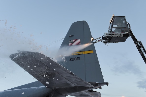 Airmen assigned to the 732nd Air Mobility Squadron deice an Alaska Air National Guard C-130H Hercules at Joint Base Elmendorf-Richardson, Alaska, Dec. 8, 2015. Deicing keeps aircraft operational despite the harsh Alaska winters by removing heavy layers of snow, ice and frost that could adversely affect flight. (U.S. Air Force photo/Alejandro Pena)