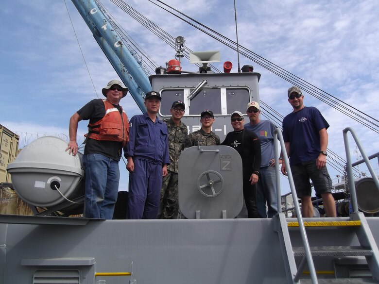 U.S. Army Corps of Engineers dive team pose with South Korean team during inspection of Busan Pier 8 in Busan, South Korea on June 6, 2017.