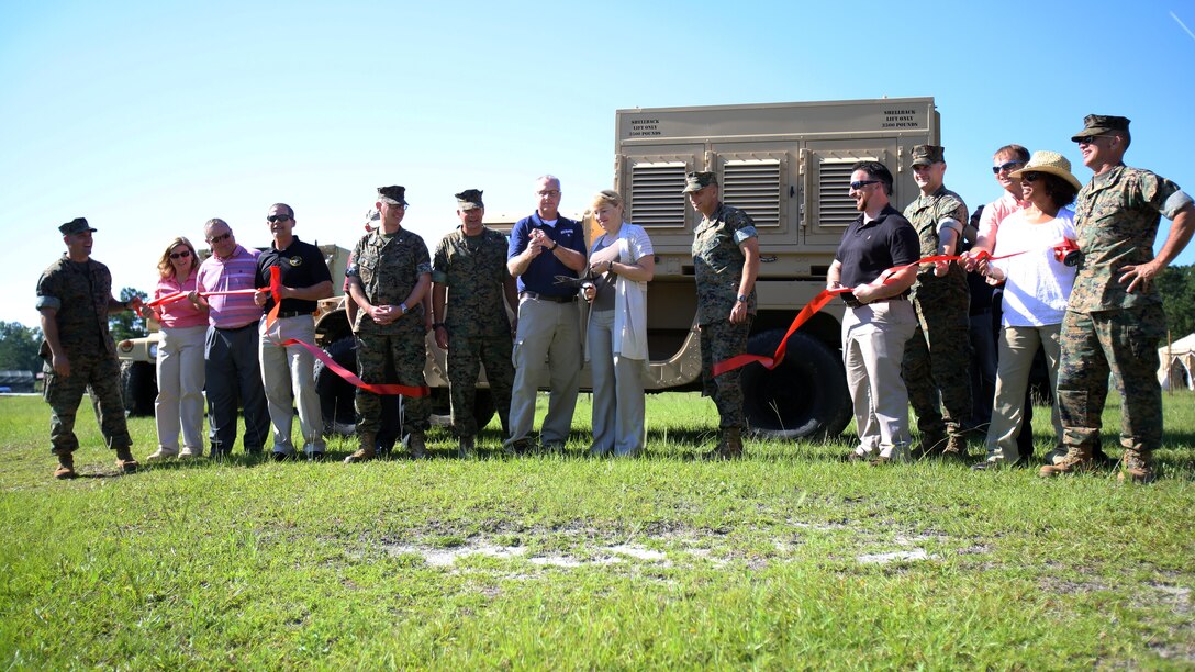 Marines assigned to Marine Air Control Squadron 2 and personnel from Program Executive Officer Land Systems cut a ribbon, unveiling new radar systems aboard Marine Corps Air Station Cherry Point, N.C., June 28, 2017. MACS-2 showcased the Common Aviation Command and Control System; AN/TPS-80 Ground/Air Task Oriented Radar; and Composite Tracking Network, and how they integrate with one another. The new equipment will provide faster and more accurate data than previous equipment which will allow Marine Air-Ground Task Force commanders to maintain better situational awareness, improving their decision ability. MACS-2 is a part of Marine Air Control Group 28, 2nd Marine Aircraft Wing. (U.S. Marine Corps Photo by Pfc. Skyler Pumphret/ Released)