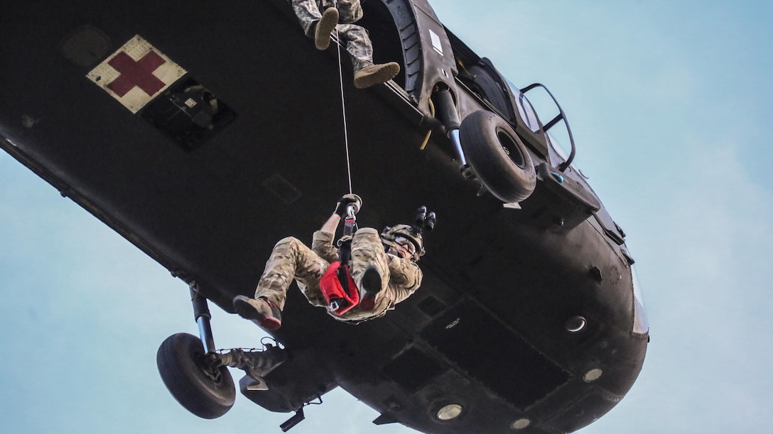Air Force Senior Airman Michael Curley descends from a UH-60 Black Hawk helicopter during New Jersey Task Force 1 joint training at Joint Base McGuire-Dix-Lakehurst, N.J., June 28, 2017. The task force, which provides advanced technical search and rescue capabilities, includes New Jersey National Guard soldiers and airmen, as well as civilians. Air National Guard photo by Master Sgt. Matt Hecht