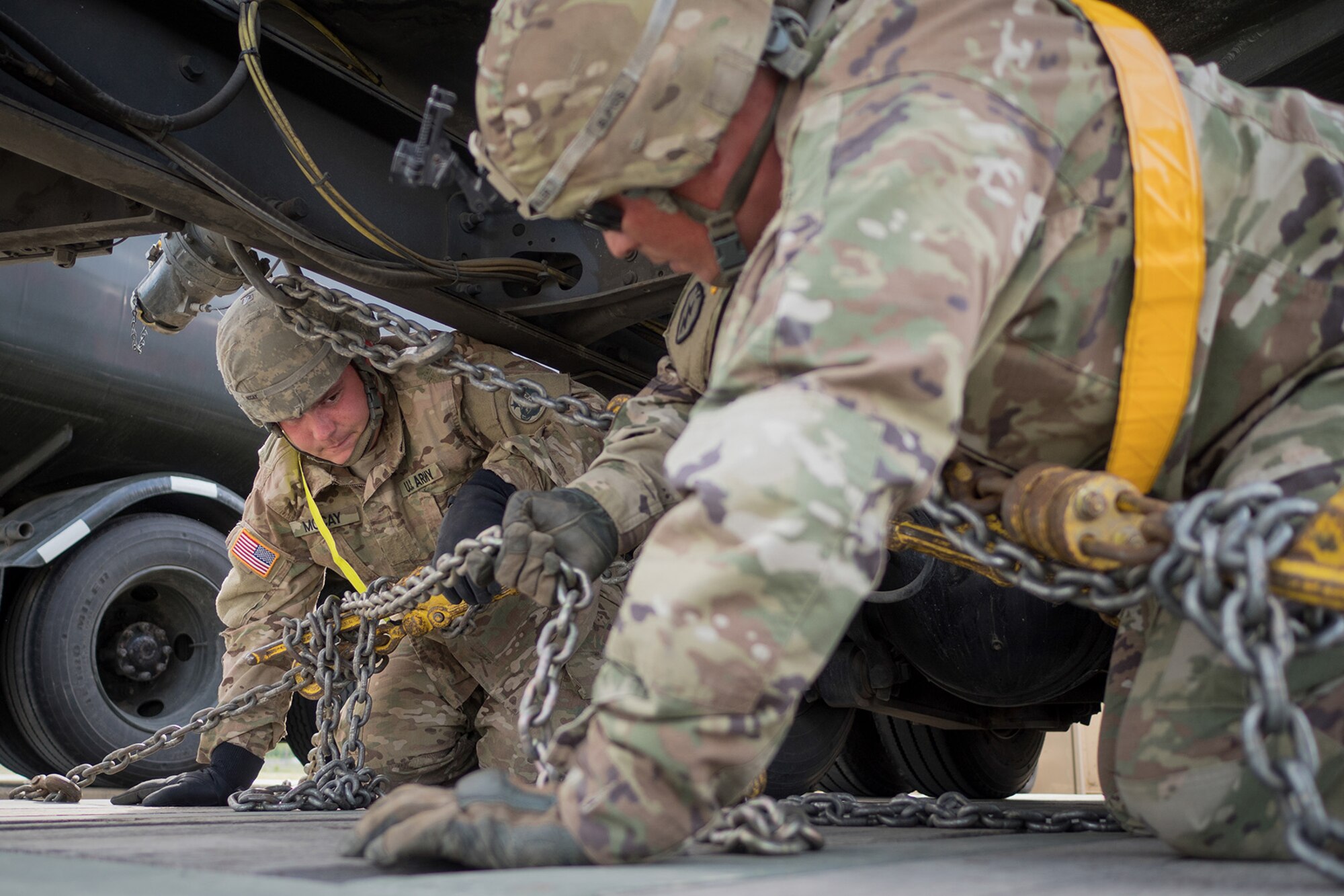 Army Pvt. Aaron McCay, a native of Colorado Springs, Colo., left, and Army Staff Sgt. Luke Miller, a native of Honolulu, both assigned to the 109th Transportation Company "Muleskinners", 17th Combat Sustainment Support Battalion, U.S. Army Alaska, secure a vehicle to a flat bed trailer on Joint Base Elmendorf-Richardson, Alaska, June 28, 2017, in support of a U.S. Air Force exercise. USARAK is at the forefront  of protecting America’s interests in the Asia-Pacific region, and is one of the U.S. military’s most centrally located power projection platforms that benefits from joint training opportunities.