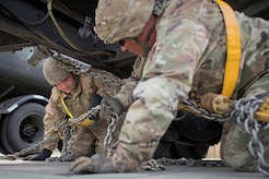 Army Pvt. Aaron McCay, a native of Colorado Springs, Colo., left, and Army Staff Sgt. Luke Miller, a native of Honolulu, both assigned to the 109th Transportation Company "Muleskinners", 17th Combat Sustainment Support Battalion, U.S. Army Alaska, secure a vehicle to a flat bed trailer on Joint Base Elmendorf-Richardson, Alaska, June 28, 2017, in support of a U.S. Air Force exercise. USARAK is at the forefront  of protecting America’s interests in the Asia-Pacific region, and is one of the U.S. military’s most centrally located power projection platforms that benefits from joint training opportunities.