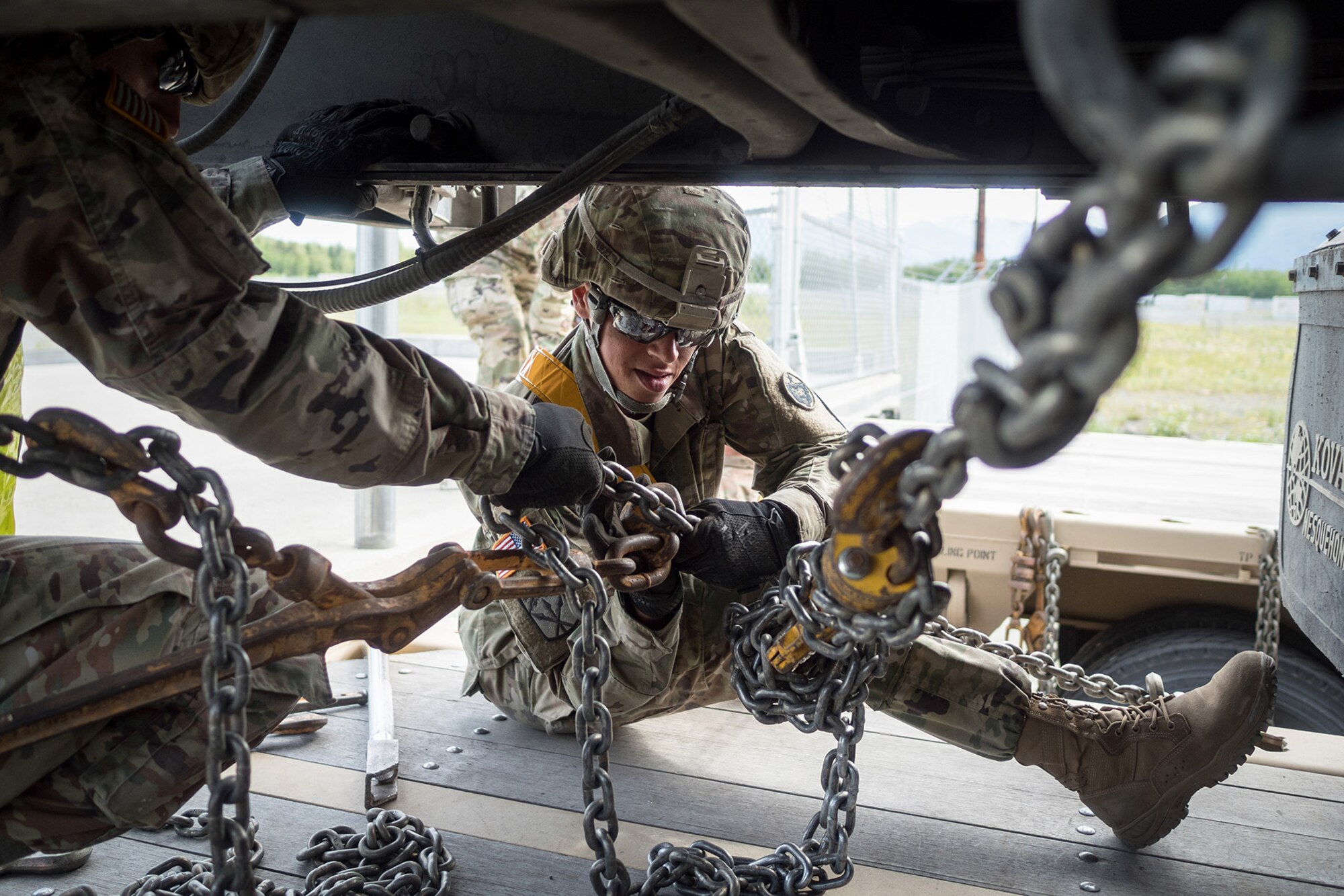 Army Staff Sgt. Jennifer Largen, a native of Orange County, Va., assigned to the 109th Transportation Company "Muleskinners", 17th Combat Sustainment Support Battalion, U.S. Army Alaska, secures a vehicle to a flat bed trailer on Joint Base Elmendorf-Richardson, Alaska, June 28, 2017, in support of a U.S. Air Force exercise. USARAK is at the forefront  of protecting America’s interests in the Asia-Pacific region, and is one of the U.S. military’s most centrally located power projection platforms that benefits from joint training opportunities.