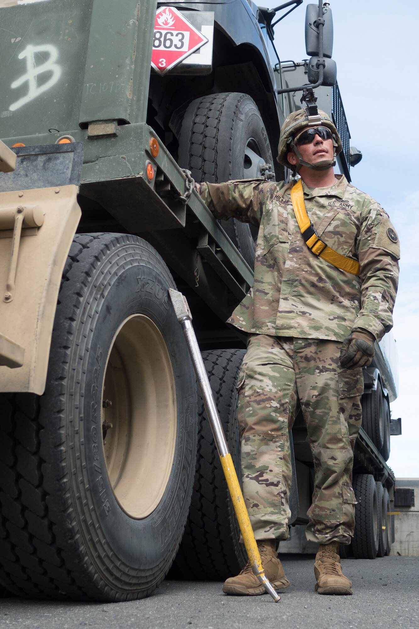 Army Staff Sgt. Luke Miller, a native of Honolulu, assigned to the 109th Transportation Company "Muleskinners", 17th Combat Sustainment Support Battalion, U.S. Army Alaska, takes a short break after loading vehicles and equipment onto a flat bed trailer on Joint Base Elmendorf-Richardson, Alaska, June 28, 2017, in support of a U.S. Air Force exercise. USARAK is at the forefront  of protecting America’s interests in the Asia-Pacific region, and is one of the U.S. military’s most centrally located power projection platforms that benefits from joint training opportunities.