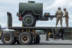 Spc. Detervious Gibson, a native of Columbus, Ga., Spc. Devonathan Hern-Martinez, a native of Colorado Springs, Colo., both assigned to the 109th Transportation Company "Muleskinners", 17th Combat Sustainment Support Battalion, U.S. Army Alaska, load a water buffalo onto a flat bed trailer on Joint Base Elmendorf-Richardson, Alaska, June 28, 2017, in support of a U.S. Air Force exercise. USARAK is at the forefront  of protecting America’s interests in the Asia-Pacific region, and is one of the U.S. military’s most centrally located power projection platforms that benefits from joint training opportunities.
