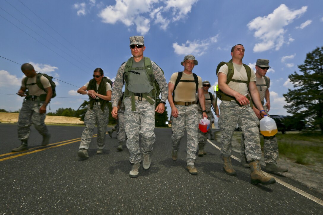 Guard, Reserve, and Active Duty airmen start the 12km foot march for the Gold during a German Armed Forces Badge for Military Proficiency test at Joint Base McGuire-Dix-Lakehurst, N.J., June 13, 2017. The test included an 1x10-meter sprint, flex arm hang, 1,000 meter run, 100 meter swim in Military Uniform, marksmanship, and a timed foot march. (U.S. Air National Guard photo by Master Sgt. Matt Hecht/Released)