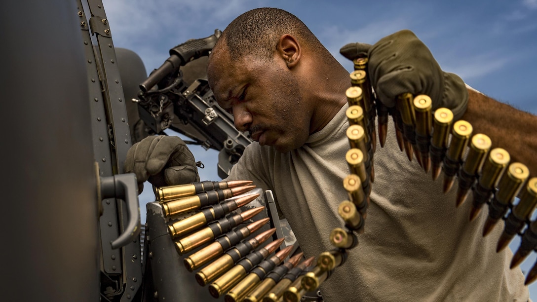 Air Force Tech. Sgt. Brandon Middleton loads .50-caliber rounds into a machine gun on an HH-60G Pave Hawk helicopter at Moody Air Force Base, Ga., June 27, 2017. Middleton is a special missions aviator assigned to the 41st Rescue Squadron. Air Force photo by Staff Sgt. Ryan Callaghan