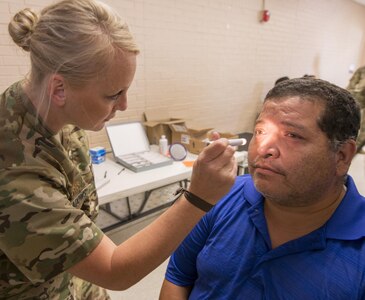 Army Maj. Jennifer Meadows, a Reserve Soldier with the 7226th Medical Support Unit, examines the eyes of Armando Corona inside the El Cenizo Community Center June 20. Nearly 200 Soldiers and five Navy opticians participated in an Innovative Readiness Training mission to provide free medical care and other services to economically distressed colonias in the Laredo area near the Texas-Mexico border.