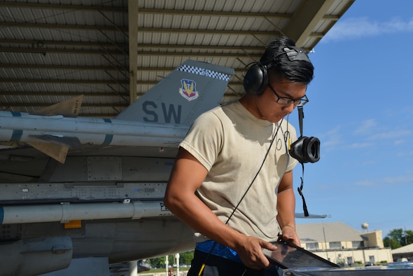 U.S. Air Force Airman 1st Class Robert Owens, 20th Aircraft Maintenance Squadron, Shooters Aircraft Maintenance Unit tactical aircraft maintainer, refers to his tablet prior to marshalling a 55th Fighter Squadron (FS) F-16CM Fighting Falcon at Shaw Air Force Base, S.C., June 26, 2017. Pilots, maintainers and intelligence Airmen assigned to the 55th FS participate in Red Flag exercises at Nellis Air Force Base, Nev., to gain experience and maintain combat readiness for deployments. (U.S. Air Force photo by Airman 1st Class Destinee Sweeney)