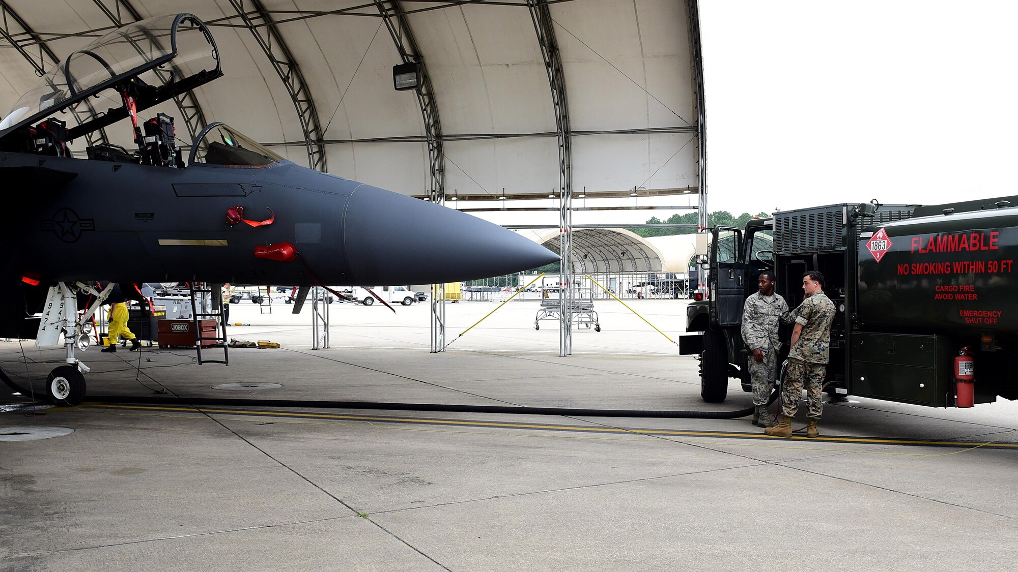 Airman 1st Class Sean Elliott, 4th Logistics Readiness Squadron fuels specialist, and U.S. Marine Corps Cpl. Jordan Kranz, Marine Wing Support Squadron 271 bulk fuel specialist, refuel an F-15E Strike Eagle, June 22, 2017, at Seymour Johnson Air Force Base, North Carolina. Airmen from the 4th LRS trained 11 Marines on the R-11 aircraft refueling vehicle in two days, prior to a deployment. (U.S. Air Force photo by Airman 1st Class Kenneth Boyton)