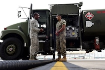 Senior Airman Antoine Borum, 4th Logistics Readiness Squadron fuels specialist, and U.S. Marine Corps Lance Cpl. Ronny Palathinkal, Marine Wing Support Squadron 271 bulk fuel specialist, prepare to refuel an F-15E Strike Eagle, June 22, 2017, at Seymour Johnson Air Force Base, North Carolina. The Marines are training to use the R-11 aircraft refueling vehicle before they deploy to Morón Air Base, Spain.  (U.S. Air Force photo by Airman 1st Class Kenneth Boyton)