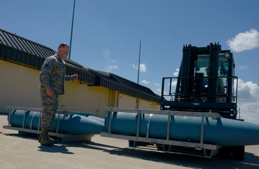 Staff Sgt. Brenton Gibbs, 5th Munitions Squadron munitions inspector, guides Senior Airman Charles Hamilton, 5th Munitions Squadron stockpile management support technician, with an inert BDU-56 bomb during Global Strike Challenge at Minot Air Force Base, N.D., June 19, 2017. The forklift rodeo was part of many events during Global Strike Challenge. (U.S. Air Force Photo by Staff Sgt. Chad Trujillo)

