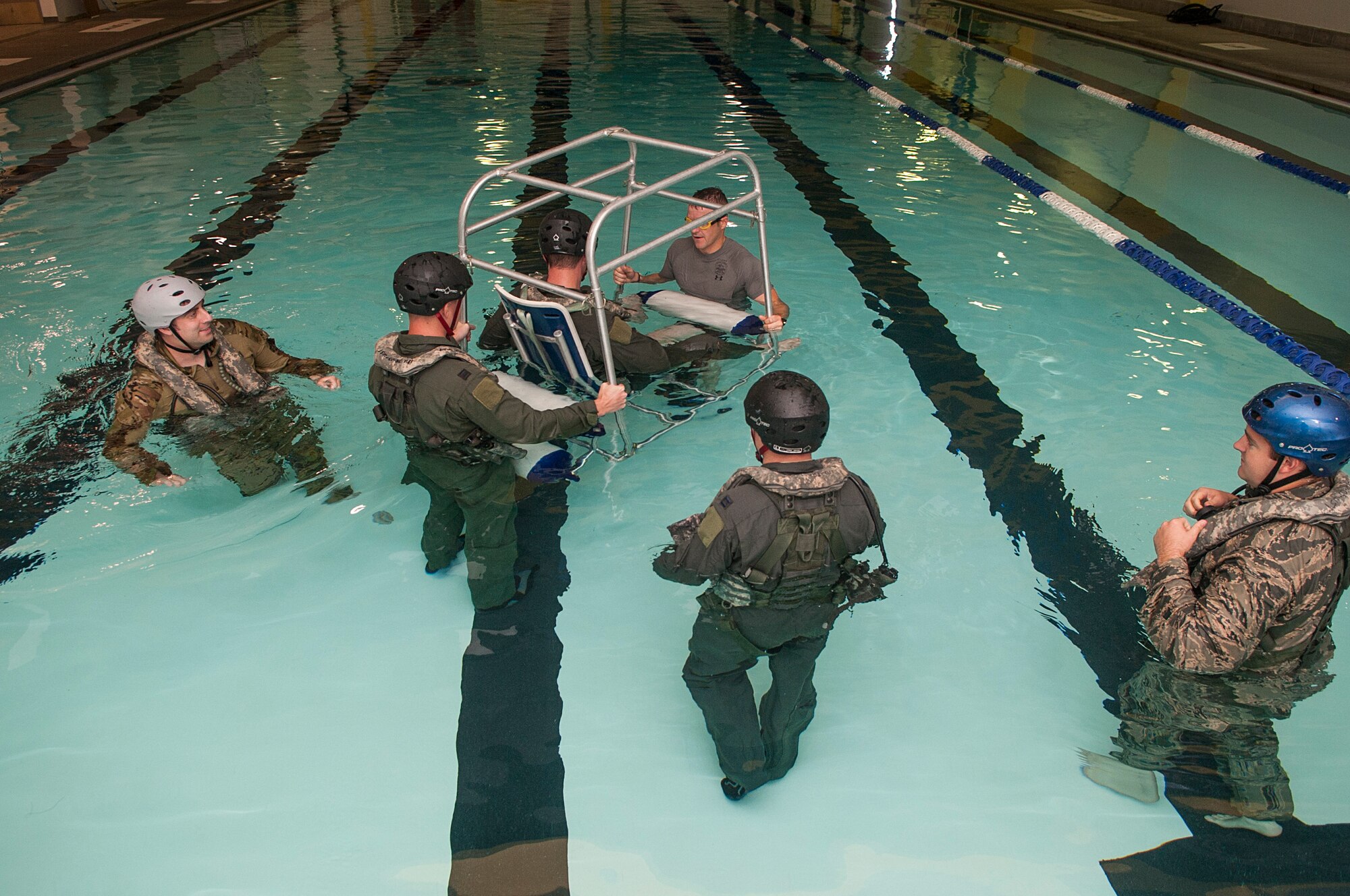 Members of the 54th Helicopter Squadron go through underwater egress survival training at Minot Air Force Base, N.D., June 22, 2017. The shallow water egress trainer allows Airmen to practice escape procedures during a simulated helicopter crash. (U.S. Air Force photo by Airman 1st Class Jonathan McElderry)