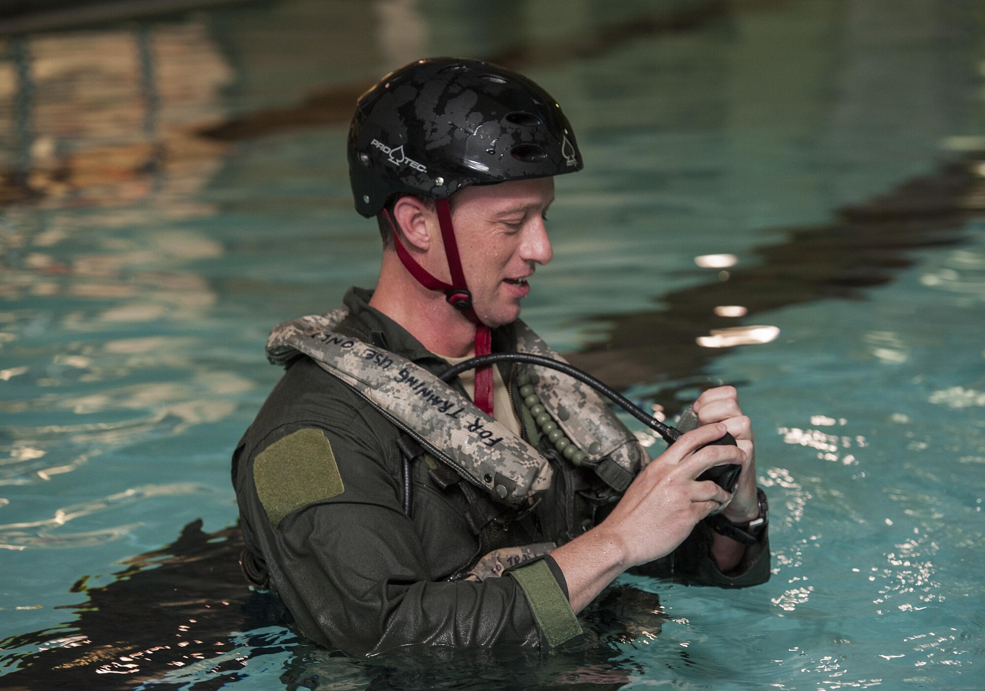 Master Sgt. David Grabher, 54th Helicopter Squadron flight engineer, tests safety equipment at Minot Air Force Base, N.D., June 22, 2017. Underwater egress survival training prepares Airmen to escape during a potential crash into water. (U.S. Air Force photo by Airman 1st Class Jonathan McElderry)