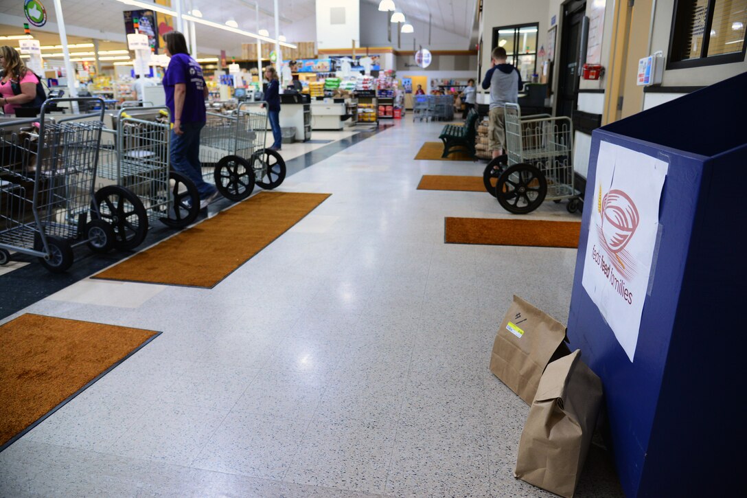 The Feds Feed Families donation collection box is located near the checkout lanes at the Malmstrom Commissary June 29, 2017, at Malmstrom Air Force Base, Mont. In 2016, the commissary donated 1,863 pounds of items and the 2017 goal is 2,000 pounds. (U.S. Air Force photo/Senior Airman Magen M. Reeves)
