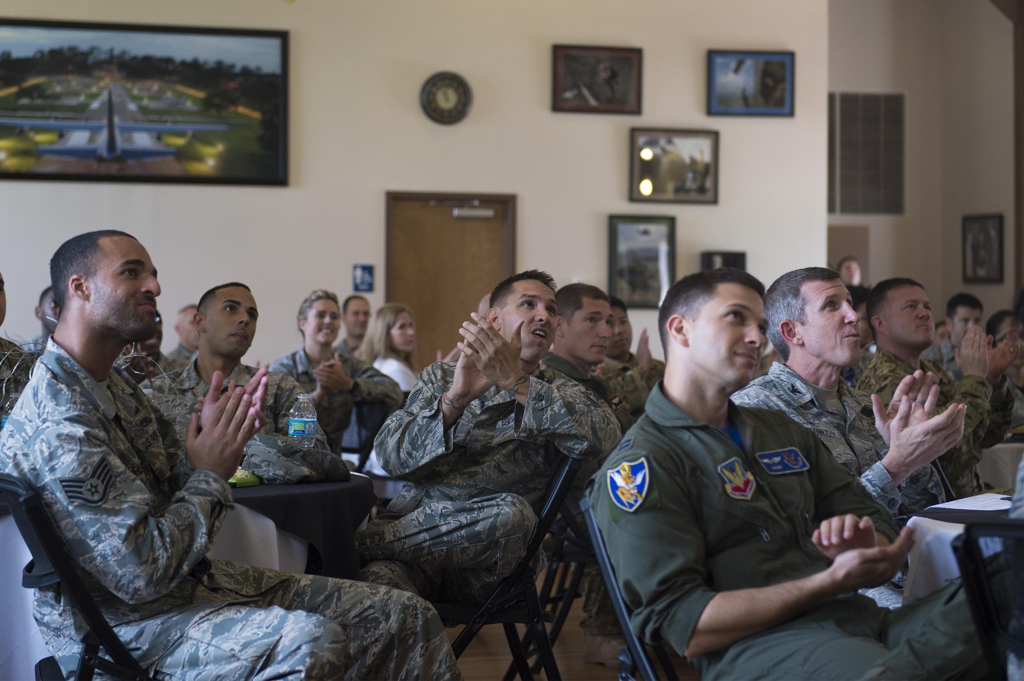 Moody Airmen applaud a video montage during the 2017 Emerge Moody, Leadership Moody graduation ceremony, June 23, 2017 at Moody Air Force Base, Ga. Approximately 30 distinguished Airmen accepted honors during the nine-month program, Emerge Moody students broadened their view of how they fit into the overall Moody and larger Air Force mission, while Leadership students learned local community agencies' best practices and challenges of leaders from non-military perspectives. (U.S. Air Force photo by Senior Airman Greg Nash)