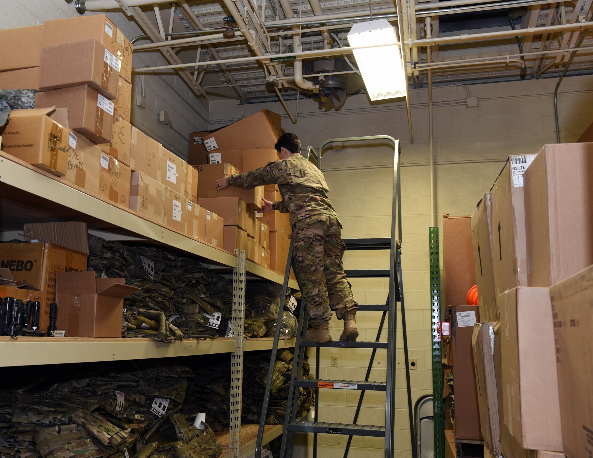 Senior Airman Christina Costa, 90th Security Support Squadron supply custodian, arranges equipment on shelves at F.E. Warren Air Force Base, Wyo., May 12, 2017. The 90th SSPTS can issue up to $100,000 worth of equipment in a day. (U.S. Air Force photo by Airman 1st Class Breanna Carter)