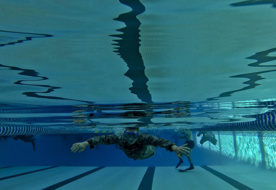 A U.S. Air Force airman from the New Jersey Air National Guard's 108th Wing swims a timed event during a German Armed Forces Badge for Military Proficiency test at Joint Base McGuire-Dix-Lakehurst, N.J., June 13, 2017. The test included an 1x10-meter sprint, flex arm hang, 1,000 meter run, 100 meter swim in Military Uniform, marksmanship, and a timed foot march. (U.S. Air National Guard photo by Master Sgt. Matt Hecht/Released)
