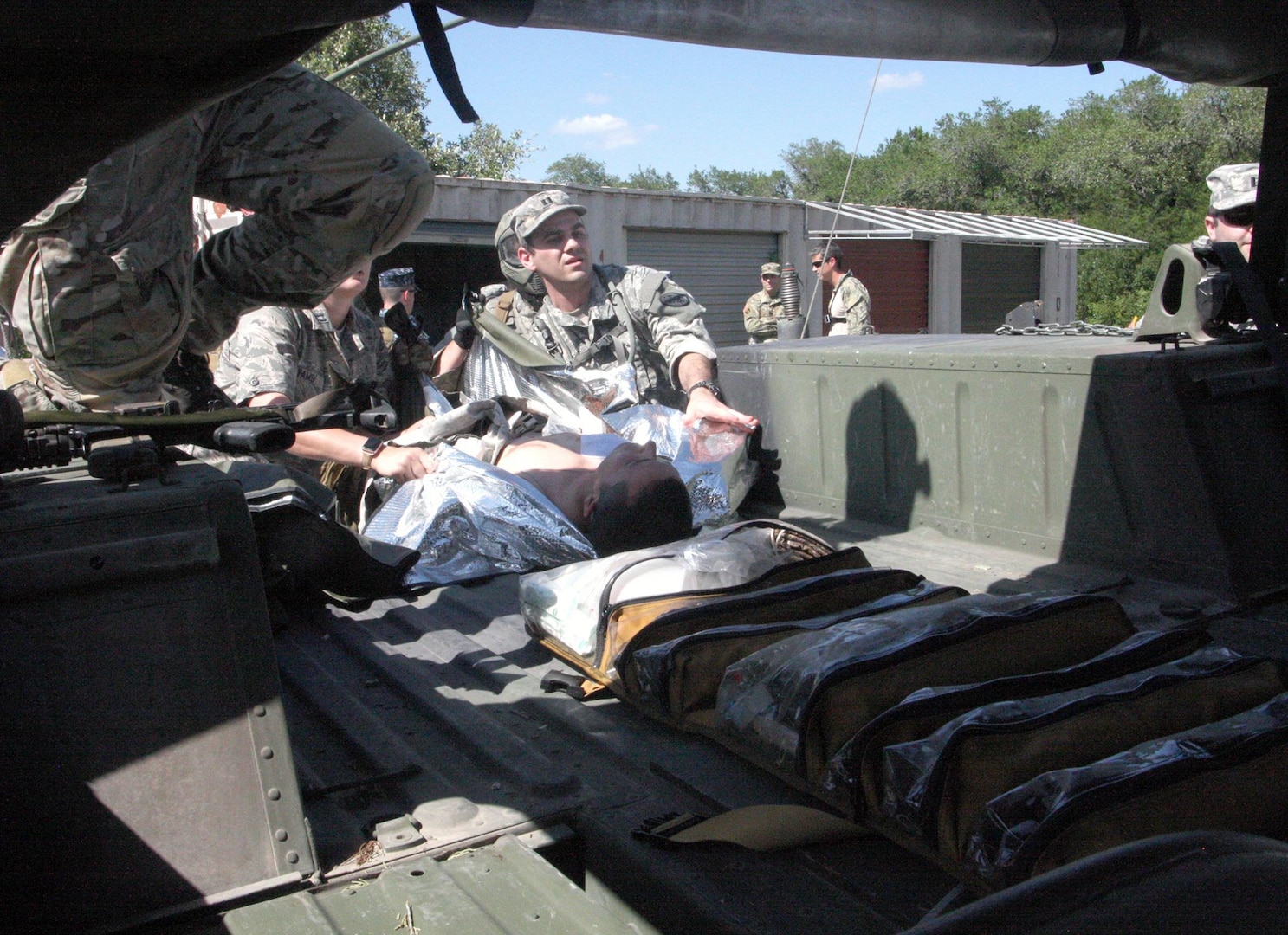 Personnel and emergency medicine physicians with the 19th Special Forces Group load simulated wounded into the back of a Humvee at Joint Base San Antonio-Camp Bullis as part of the Joint Emergency Medicine Exercise June 15.