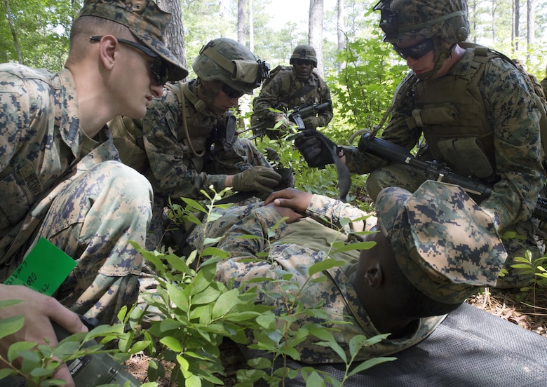 Marines with Fox Company, 2nd Battalion, 2nd Marine Regiment practice first aid on a simulated wounded pilot and strap him to a stretcher during a Tactical Recovery of Aircraft and Personnel exercise at Camp Lejeune, N.C., June 29, 2017. The Marines conducted the TRAP as part of their Certification Exercise in preparation for an upcoming deployment as the Special Purpose Marine Air-Ground Task Force-Crisis Response-Africa. Due to the time-sensitive nature of a TRAP mission, the Marines constantly train to maintain and improve their proficiency in recovering personnel and destroying or retrieving classified equipment. (U.S. Marine Corps photo by Lance Cpl. Raul Torres)