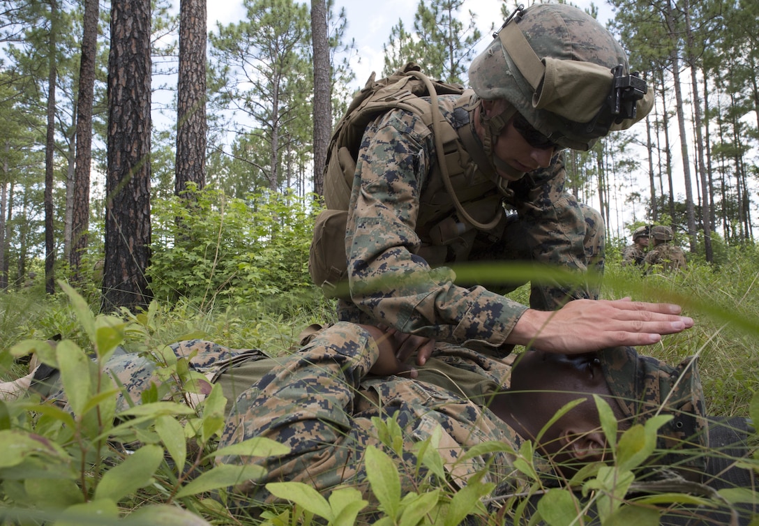 A Corpsman with Fox Company, 2nd Battalion, 2nd Marine Regiment tends to a simulated wounded pilot during a Tactical Recovery of Aircraft and Personnel exercise at Camp Lejeune, N.C., June 29, 2017. The Marines conducted the TRAP as part of their Certification Exercise in preparation for an upcoming deployment as the Special Purpose Marine Air-Ground Task Force-Crisis Response-Africa. Due to the time-sensitive nature of a TRAP mission, the Marines constantly train to maintain and improve their proficiency in recovering personnel and destroying or retrieving classified equipment. (U.S. Marine Corps photo by Lance Cpl. Raul Torres)