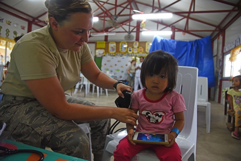 U.S. Air Force Senior Airman Danielle Delporto, medical technician with the 152nd Medical Group, Nevada Air National Guard, measures the vitals of a girl from Bogo City during Pacific Angel 2017 in Northern Cebu Province, Philippines, June 26, 2017. PACANGEL participants from six different nations work together with local nongovernmental organizations to administer medical care, including general health, optometry, dental, physical therapy and pediatrics, to the people of Northern Cebu Province. (U.S. Air Force photo by Tech. Sgt. Jeff Andrejcik)