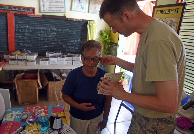 U.S. Air Force Maj. Jay Butler, optometrist with the 374th Medical Group, Yokota Air Base, Japan, tests the eye sight of a woman from Bogo City during Pacific Angel 2017 in Northern Cebu Province, Philippines, June 26, 2017. PACANGEL participants from six different nations work together with local nongovernmental organizations to administer medical care, including general health, optometry, dental, physical therapy and pediatrics, to the people of Northern Cebu Province. (U.S. Air Force photo by Tech. Sgt. Jeff Andrejcik)