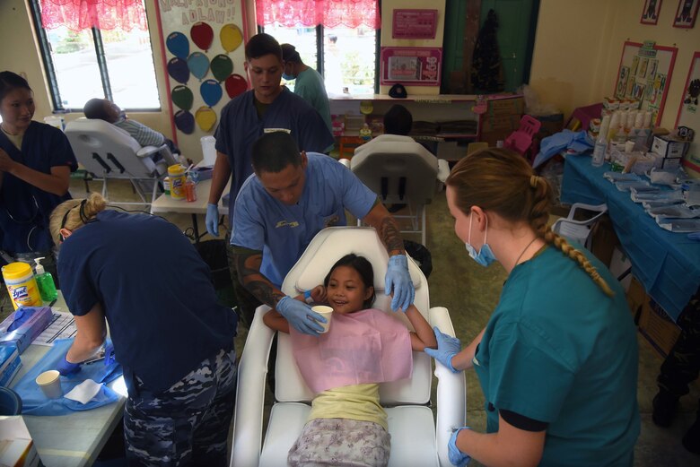 A girl from Bogo City finishes her dental treatment during Pacific Angel (PACANGEL) 2017 in Northern Cebu Province, Philippines, June 26, 2017. PACANGEL participants from six different nations are working with local nongovernmental organizations to administer medical care, including general health, optometry, dental, physical therapy and pediatrics, to the people of Northern Cebu Province. (U.S. Air Force photo/Tech. Sgt. Jeff Andrejcik)