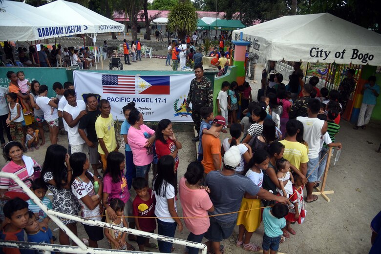 Local community member’s form a line outside of a Pacific Angel 2017 health services site in Northern Cebu Province, Bogo City, Philippines, June 26, 2017. PACANGEL is a multilateral humanitarian assistance civil military engagement, which improves military-to-military partnerships in the Pacific while also providing medical health outreach, civic engineering projects and subject matter exchanges among partner forces.  (U.S. Air Force photo by Tech. Sgt. Jeff Andrejcik)