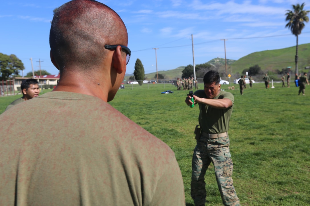 A U.S. Marine assigned to the 1st Battalion, 11th Marines, Charlie Battery, the non-lethal weapons company for the 15th Marine Expeditionary Unit (MEU), demonstrated he can still maintain cognizance and bearing with a hostile individual after taking a shot of OC spray to the face during OC certification on Camp Pendleton, Feb. 14, 2017. The 15th MEU used this training to sharpen their skills in a variety of non-lethal weapons tactics they would use to stabilize hostile situations. These non-lethal capabilities add to the flexibility of the MEU to shape actions across the range of military operations to resolve conflict anyway in the world. (U.S. Marine Corps photo by Lance Cpl. Jacob Pruitt)