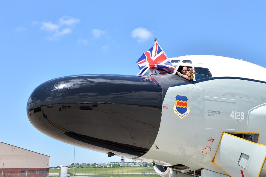 British Royal Air Force Squadron Leader Ade Pickup, an exchange officer with the 338th Combat Training Squadron, flies the United Kingdom flag and poses with Hugh Trenchard, a special teddy bear, following a training flight on an RC-135 here June 29. Hugh is an honorary member of the RAF and has been flying on aircraft all across the U.S. this year to commemorate the 100th anniversary of the Royal Air Force in 1918 and also the U.S. Air Force 70th anniversary this year. (U.S. Air Force photo by Charles Haymond)