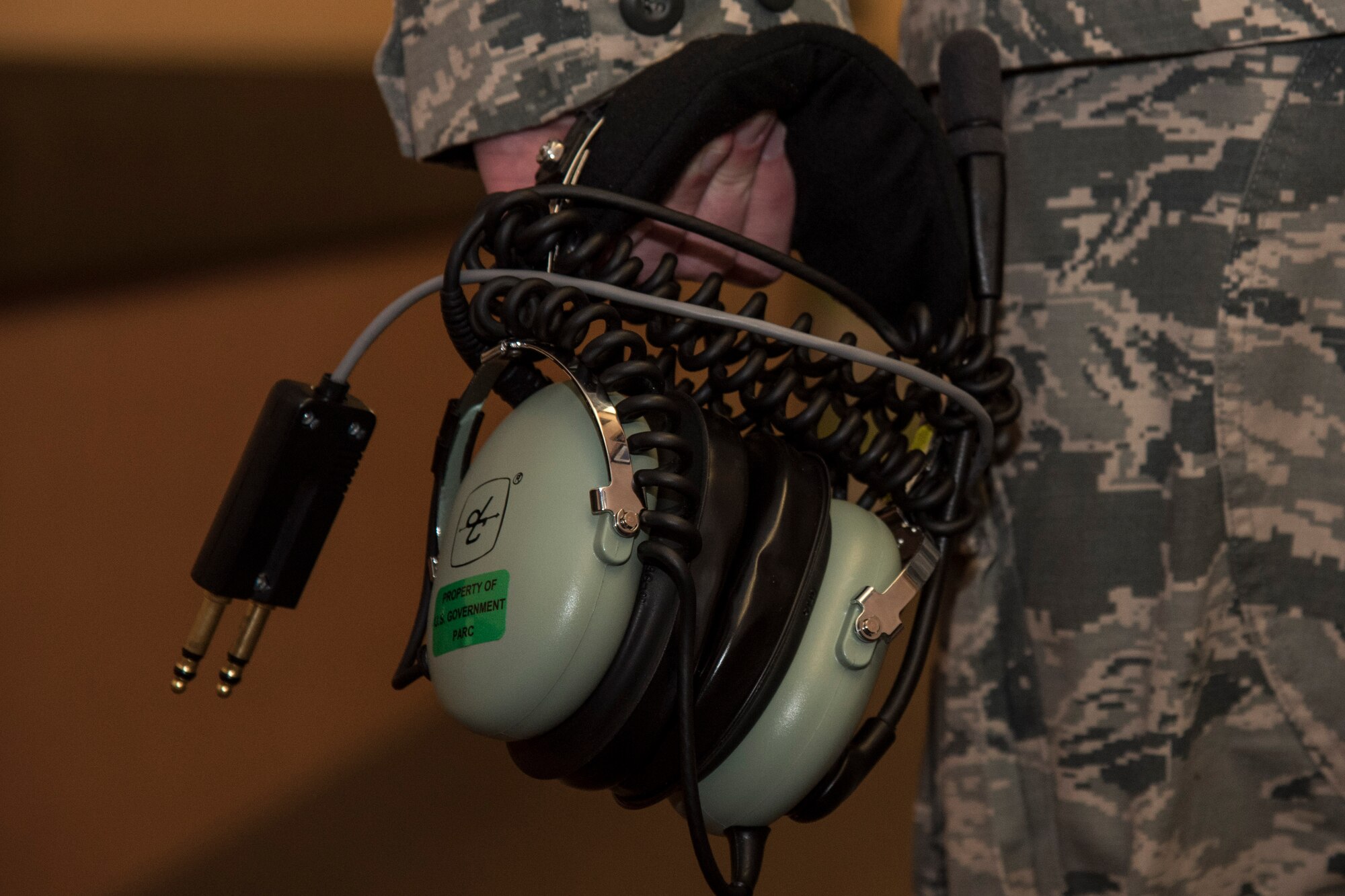 U.S. Air Force Senior Airman Christopher McWhorter, a 610th Air Control Flight weapons director, walks down the hallway with an air controller headset during RED FLAG-Alaska, at Eielson Air Force Base, Alaska, June 20, 2017. The headset provides controllers with zero noise pollution so they can clearly communicate to all players in the airspace. While in Misawa Air Base, Japan, controllers coordinate with Japan Air Self-Defense Force's 3rd Air Wing to work on interoperability which further strengthens their tactical fluidity. (U.S. Air Force photo by Airman 1st Class Sadie Colbert)