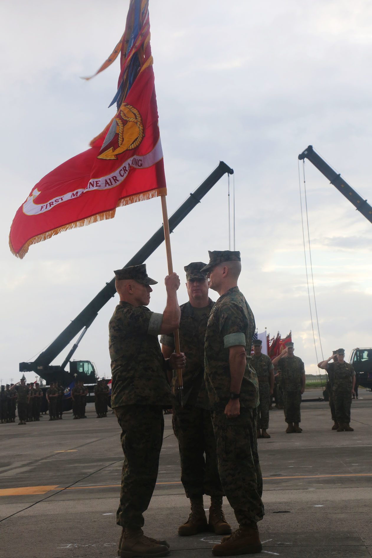 U.S. Marine Corps Brig. Gen. Thomas D. Weidley (left), the incoming 1st Marine Aircraft Wing commanding general takes the unit colors from Maj. Gen. Russell A. Sanborn (right), outgoing commanding general, representing the passing of command during a change of command ceremony at Marine Corps Air Station Futenma, Okinawa, Japan, June 29, 2017. Sanborn will assume command of Marine Forces Europe and Africa. (U.S. Marine Corps photo by Lance Cpl. Isabella Ortega)