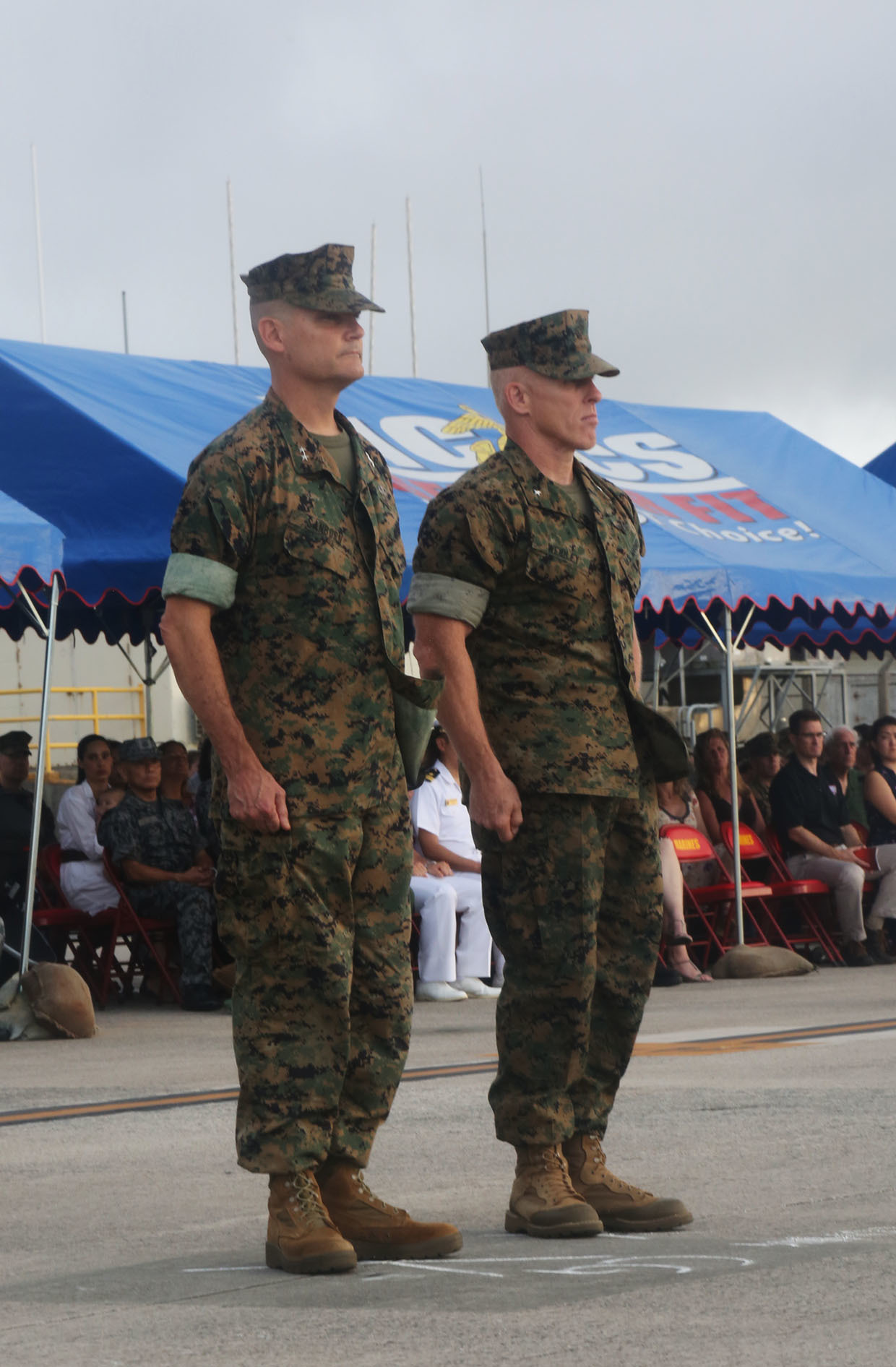 U.S. Marine Corps Maj. Gen. Russell A. Sanborn (left), outgoing 1st Marine Aircraft Wing commanding general, stands at attention with Brig. Gen. Thomas D. Weidley (right), the incoming commanding general, during a change of command ceremony at Marine Corps Air Station Futenma, Okinawa, Japan, June 29, 2017. Sanborn relinquished command to Weidley and will assume command at Marine Forces Europe and Africa. (U.S. Marine Corps photo by Lance Cpl. Isabella Ortega)