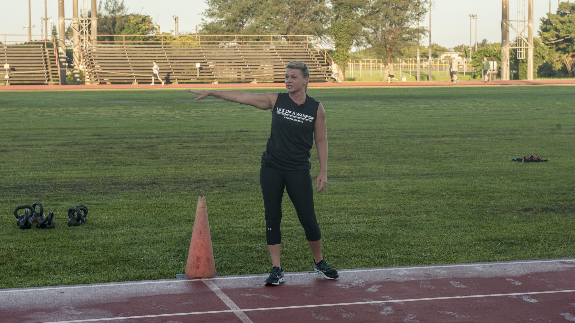 Missy Cornish, wife of Brig. Gen. Barry Cornish, 18th Wing Commander, leads a Warrior Training Fitness session June 28, 2017, at the Risner Fitness and Sports Complex on Kadena Air Base, Japan. Cornish lead and helped start the Warrior Training Fitness workout series. (U.S. Air Force photo/Airman 1st Class Greg Erwin)