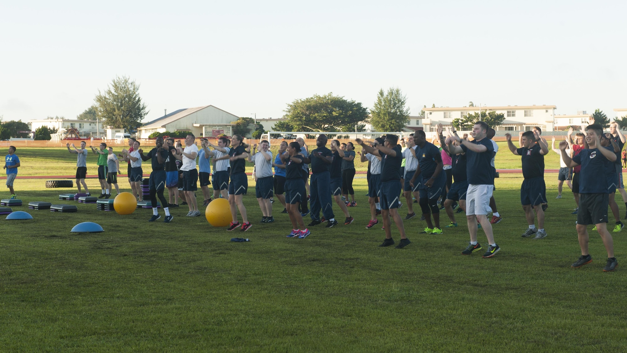 Service and family members warm-up for a Warrior Training Fitness workout June 28, 2017, at the Risner Fitness and Sports Complex, Kadena Air Base, Japan. The workout emphasized physical resiliency of the four pillars based on the Life of a Warrior ethos. (U.S. Air Force photo/Airman 1st Class Greg Erwin)