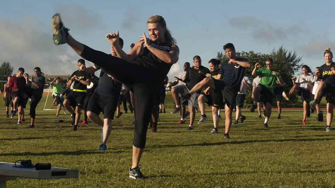 Missy Cornish, fitness professional, leads a Muay Thai exercise as a part of a Warrior Training Fitness workout June 28, 2017, at the Risner Fitness and Sports Complex, Kadena Air Base, Japan. Cornish developed the Warrior Training Fitness program as a way to reinforce physical resilience and promote alternative workout methods. (U.S. Air Force photo/Airman 1st Class Greg Erwin)