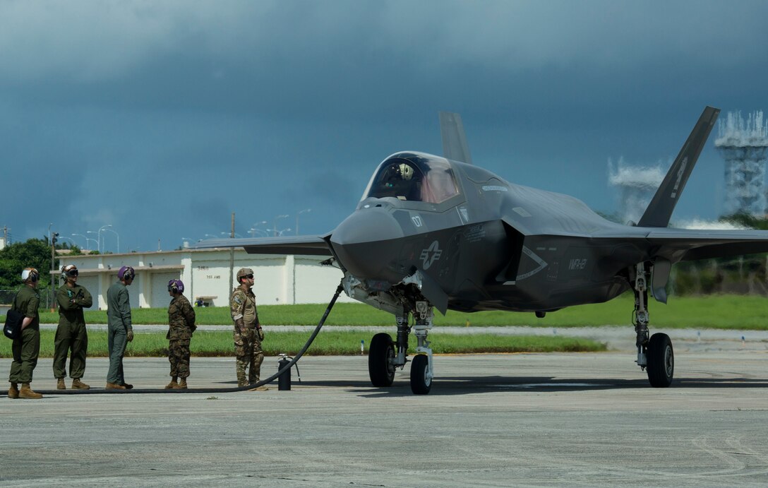 U.S. Marines and Airmen conduct a hot pit refuel on the F-35B Lightning II aircraft at Kadena Air Force Base, Okinawa, Japan, June 27, 2017. The Marines are with Marine Fighter Attack Squadron 121, Marine Aircraft Group 12, 1st Marine Aircraft Wing, and the Airmen are with 18th Logistics and Readiness Squadron, 353 Special Operations Group, 18th Wing. The two-day exercise enabled the U.S. Air Force and Marine Corps to improve interoperability and develop tactics, techniques and procedures involving the new aircraft for future joint FARP operations throughout the Indo-Asia Pacific Theater. (U.S. Marine Corps photo by Lance Cpl. Deseree Kamm)