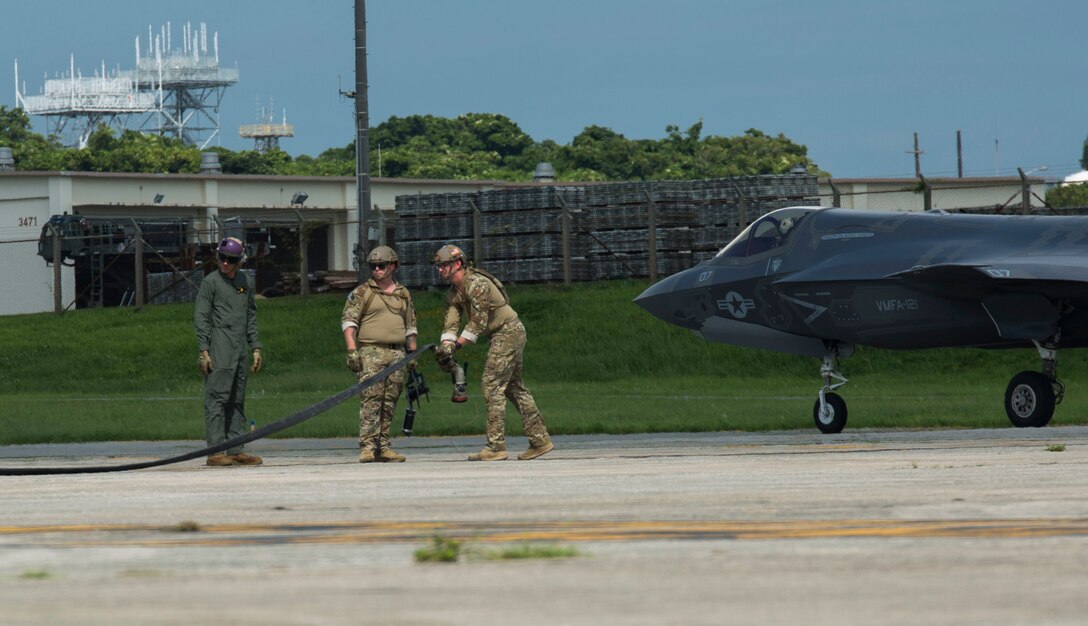 U.S. Marines and Airmen finish a hot pit refuel on the F-35B Lightning II aircraft at Kadena Air Force Base, Okinawa, Japan, June 27, 2017. The Marines are with Marine Fighter Attack Squadron 121, Marine Aircraft Group 12, 1st Marine Aircraft Wing, and the Airmen are with 353 Special Operations Group, 18th Wing. The two-day exercise enabled the U.S. Air Force and Marine Corps to improve interoperability and develop tactics, techniques and procedures involving the new aircraft for future joint FARP operations throughout the Indo-Asia Pacific Theater. (U.S. Marine Corps photo by Lance Cpl. Deseree Kamm)