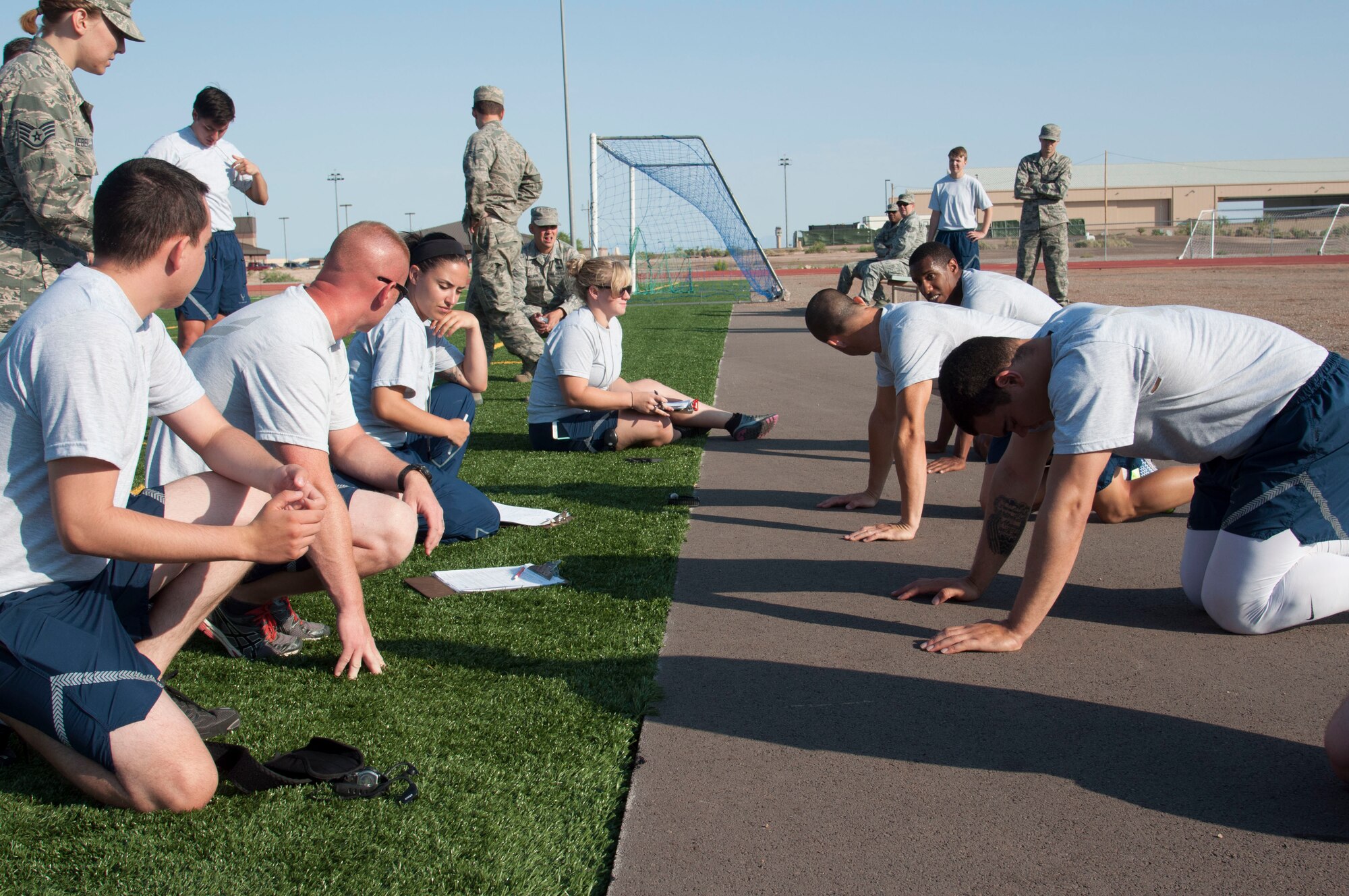 Airmen from the 49th Maintenance Group prepare for the push-up muscular component of the 49th MXG's 101 Days of Training 100 percent PT competition at Holloman Air Force Base, June 27, 2017. On March 6, 2017, the 49th MXG began invigorating the training culture by strengthen the maintainers’ competence and focus on upgrade and proficiency training through events such as noncommissioned officer speed mentoring, 100 percent PT competition, ‘How to be a Millionaire’ brief, and a Consolidated Tool Kit (CTK)/Aircraft Forms and Documentation competition took place over the 15-week period. (Courtesy photo)