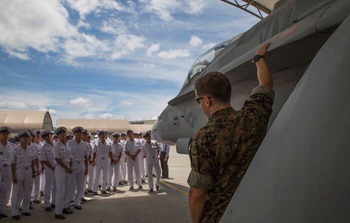 U.S. Marine Corps Capt. Michael M. Rasmussen, assistant operations chief with Marine Air Group (MAG) 12, shows Japan Maritime Self-Defense Force aviation students an F/A-18C Hornet during a Junior Officer Exchange Program visit at Marine Corps Air Station Iwakuni, Japan, June 21, 2017. Students came from Ozuki Air Base to learn about MAG-12 and the F/A-18. They familiarized themselves with the aircraft during the visit by taking part in a flight simulator and by visiting a static display. Hosting the cadets helps them understand the relationship Japan holds with U.S. Marines. (U.S. Marine Corps photo by Lance Cpl. Gabriela Garcia-Herrera)