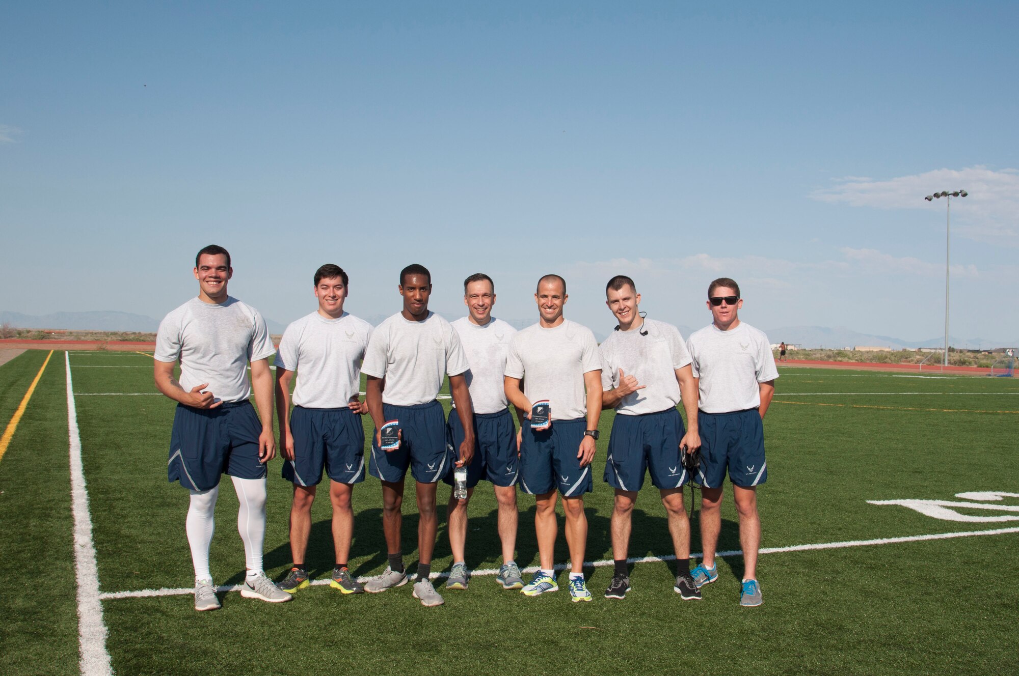 Col. Lyle Drew, (center) 49th Maintenance Group commander, poses with the competitors from the 49th MXG's 101 Days of Training 100 percent PT competition on Holloman Air Force Base, June 27, 2017. On March 6, 2017, the 49th MXG began invigorating the training culture by strengthen the maintainers’ competence and focus on upgrade and proficiency training through events such as noncommissioned officer speed mentoring, 100 percent PT competition, ‘How to be a Millionaire’ brief, and a Consolidated Tool Kit (CTK)/Aircraft Forms and Documentation competition took place over the 15-week period. (Courtesy photo)