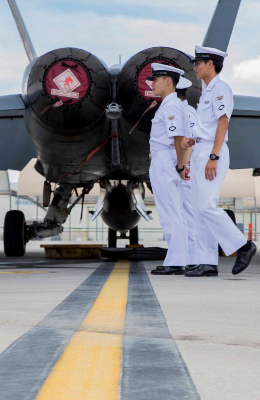 Japan Maritime Self-Defense Force aviation students learn about an F/A-18C Hornet during a Junior Officer Exchange Program visit at Marine Corps Air Station Iwakuni, Japan, June 21, 2017. Students from Ozuki Air Base came to learn about Marine Air Group (MAG) 12 and the F/A-18. They familiarized themselves with the aircraft during the visit by taking part in a flight simulator and by visiting a static display. Hosting the cadets helps them understand the relationship Japan holds with U.S. Marines. (U.S. Marine Corps photo by Lance Cpl. Gabriela Garcia-Herrera)