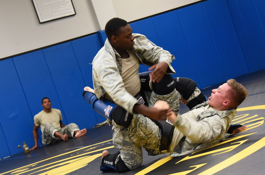 Senior Airman Jerome Scurry (top), 512th Security Forces Squadron reservist, wrestles with another trainee during Phoenix Raven training June 15, 2017, at Joint Base McGuire-Dix-Lakehurst, New Jersey.Raven training includes instruction and realistic practical exercises in antiterrorism and force protection, weapon system security, verbal judo, combatives, tactical baton employments and advanced firearms proficiency. (U.S. Air Force photo/Master Sgt. Jaimie Powell)