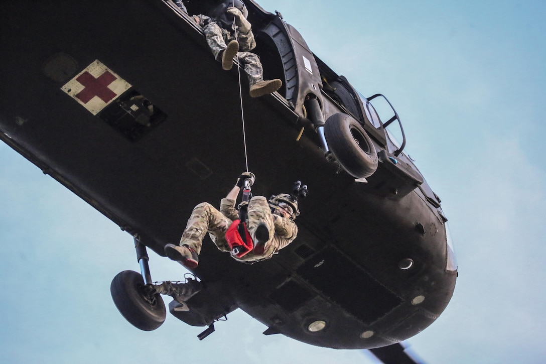 Air Force Senior Airman Michael Curley descends from a UH-60 Black Hawk helicopter during New Jersey Task Force 1 joint training at Joint Base McGuire-Dix-Lakehurst, N.J., June 28, 2017. The task force, which provides advanced technical search and rescue capabilities, includes New Jersey National Guard soldiers and airmen, as well as civilians. Air National Guard photo by Master Sgt. Matt Hecht