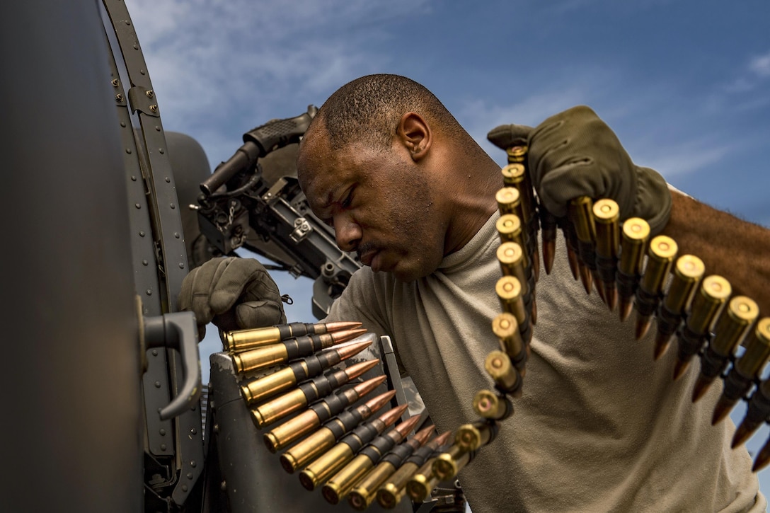 Air Force Tech. Sgt. Brandon Middleton loads .50-caliber rounds into a machine gun on an HH-60G Pave Hawk helicopter at Moody Air Force Base, Ga., June 27, 2017. Middleton is a special missions aviator assigned to the 41st Rescue Squadron. Air Force photo by Staff Sgt. Ryan Callaghan