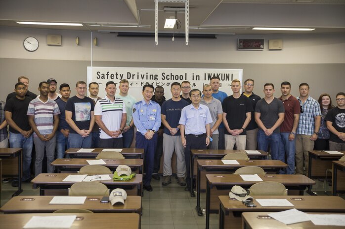 Marine Corps Air Station Iwakuni residents pose with Japanese locals during a free driving class held for station residents in Iwakuni City, Japan, June 28, 2017. The station residents learned traffic rules and manners, and drove in a live course with Japanese instructors and translators. Twenty station residents were invited to take part in the short, educational workshop aimed to decrease the number of traffic accidents and violations caused by station residents. (U.S. Marine Corps photo by Lance Cpl. Carlos Jimenez)