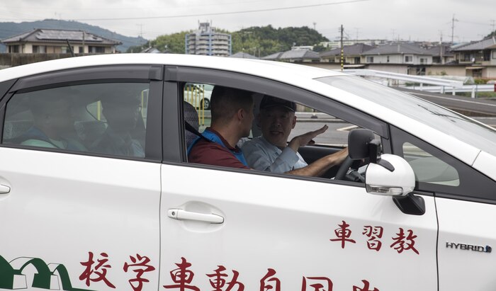 A Japanese driving instructor gives tips to a Marine Corps Air Station Iwakuni resident during a free driving class held for station residents in Iwakuni City, Japan, June 28, 2017. The station residents learned traffic rules and manners and drove in a live course with Japanese instructors and translators. Twenty station residents were invited to take part in the short, educational workshop aimed to decrease the number of traffic accidents and violations caused by air station residents. (U.S. Marine Corps photo by Lance Cpl. Carlos Jimenez)